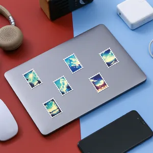 Close-up of dream sky scenery stamp stickers on laptop, forest healing style decor.