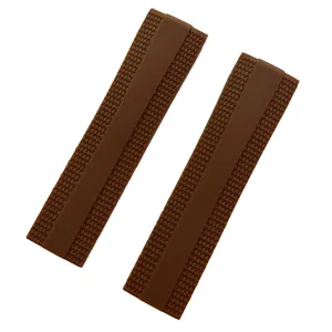Detail shot of brown silicone watch strap featuring textured grid pattern and smooth center stripe.