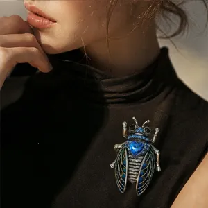 Exquisite retro rhinestone cicada brooch, detailed metal craft with blue crystal design for women.