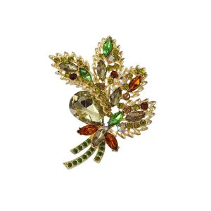 Detailed view of luxury crystal leaf brooch featuring sparkling multi-color rhinestones.