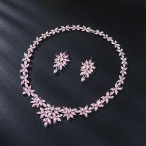 Detailed flat lay view of an elegant pink marquise crystal necklace and earrings set.