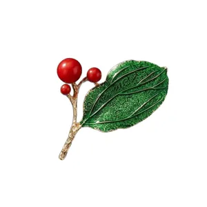 Elegant enamel red berry and green leaf brooch, stylish gold-toned plant pin for women's daily wear.