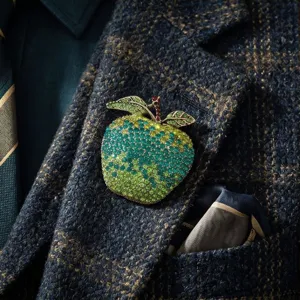 Detailed view of the luxury gradient green rhinestone apple brooch, elegant crystal fruit corsage pin.