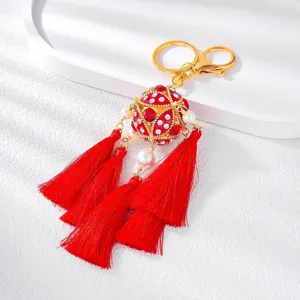 Chinese style rhinestone hydrangea keychain with vibrant red tassels and metal alloy ring.
