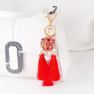 Red rhinestone beaded ball keychain with tassels detailed view for bags and car keys.