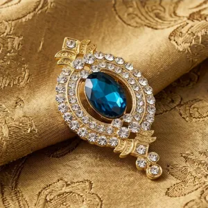 Vintage Blaue Edelstein Brosche, goldfarbenes Metall mit funkelnden klaren Strasssteinen.