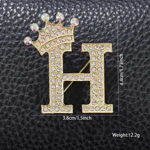 Κομψή χρυσή καρφίτσα με στραζ κορώνα γράμμα H για γυναικεία ρούχα και αξεσουάρ μόδας.