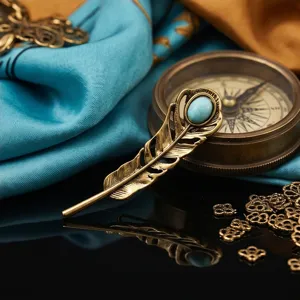 Vintage feather brooch with turquoise stone, elegant metal lapel pin for suits and blazers.