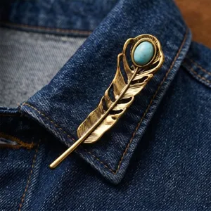 Vintage gold feather brooch with turquoise stone, elegant fashion suit lapel pin accessory.