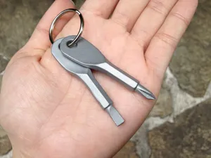 Vista detallada del mini destornillador EDC en forma de llave, con puntas plana y cruz.