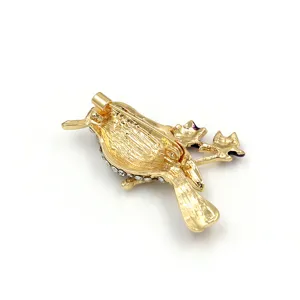 Detail view of gold alloy hummingbird crystal brooch back structure, elegant accessory.
