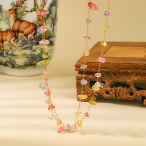 Colorful gemstone chip necklace detail shot, elegant fine gold chain design for women.