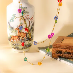 Delicate multi-color crystal flower beaded necklace detail view with vibrant floral charms.