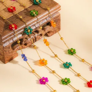 Colorful crystal beaded flower necklace detail shot, sweet minimalist design gold chain jewelry.