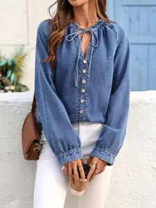 Detail shot of the V-neck buttoned denim top sleeve and front button closure design.