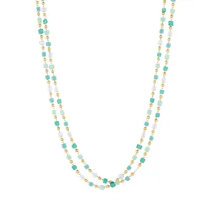 Close-up view of the intricate green and transparent crystal cube beads on the chain detail.