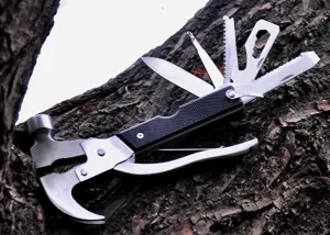 Close-up detail of stainless steel multi-tool featuring folding knife, saw, and hammer head.