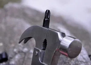 Multifunctional claw hammer detail shot, portable hardware tool with screwdriver bit.