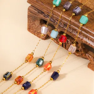 Detail view of colorful geometric bead choker necklace with delicate gold chain design.
