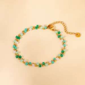 Close-up detail of double-layer green cube beaded bracelet with gold metal balls and clasp.