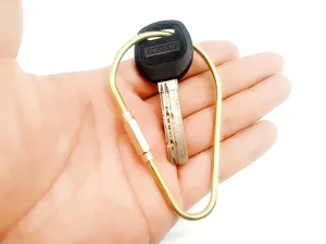 Brass wire keychain detail, durable metal loop ring, portable EDC tool accessory display.