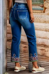 Detailed back view of women stretch straight denim jeans featuring colorful geometric ankle embroidery.