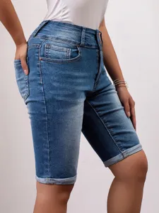 Women's slim-fit denim shorts detail featuring high waist, washed finish, and rolled-up cuffs.