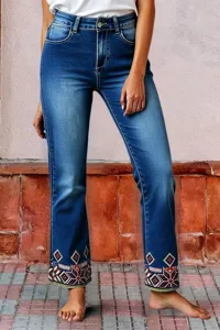 Detailed view of women's high-waisted straight denim jeans with colorful cuff embroidery.