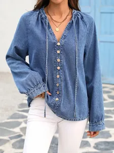 Detailed view of casual V-neck denim top with button closure, long sleeves and drawstring.