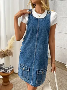 Detail view of womens washed denim overall dress, casual loose fit with front pockets.