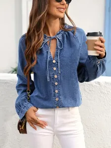 Detailed view of women's long sleeve denim top with V-neck, drawstring and buttons.