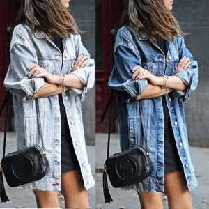Detail shot of oversized street style denim jacket, long sleeves, classic lapel, casual chic look.
