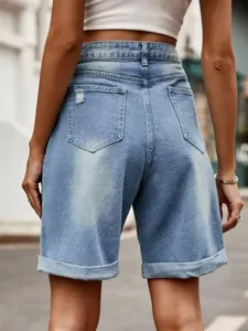 Back view detail of high waist rolled hem denim shorts featuring light blue wash and pockets.