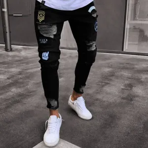 Mens distressed slim fit ripped black denim jeans with cool custom military patches detailing.