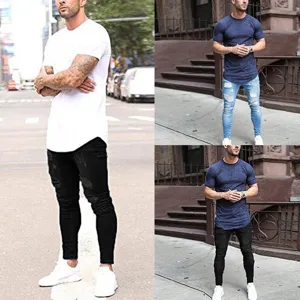 Detailed view of men's slim fit ripped jeans and casual t-shirt streetwear outfit.