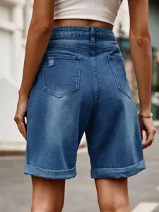 Detail view of high-waist denim shorts showcasing back pockets and stylish rolled hem.