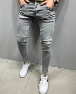 Detailed view of men's slim fit grey denim skinny jeans showing close-up texture and cut.