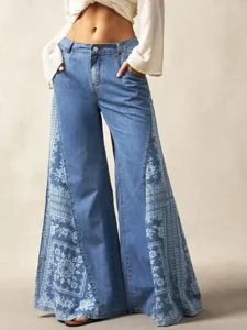 Detail shot of wide-leg denim jeans featuring floral print side panels and functional pockets.