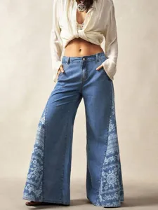 Bohemian women's plus-size wide-leg denim pants with floral patchwork and casual pockets.