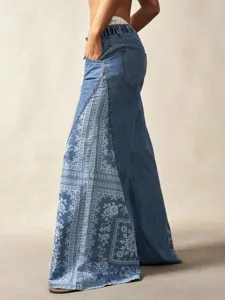 Detail view of the bohemian floral patterned wide-leg denim jeans side pocket design.