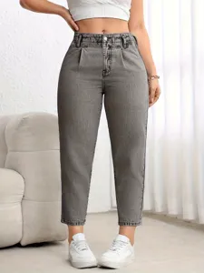 Detail view of grey washed high waist straight denim pants with pleated waist design.