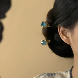 Blue crystal ball hair pin detail view, elegant Chinese style Hanfu bun headdress accessory.