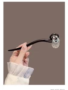 Elegant wooden hair stick featuring a vintage crescent moon tassel design, perfect for Hanfu.