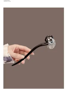 Detail view of elegant Chinese style wooden hair stick with crescent tassel for Hanfu styling.