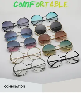 Vista detallada de gafas de sol redondas de metal para mujer, con lentes degradadas y estilo único.