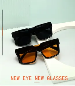 Detail view of oversized square sunglasses with one-piece lens, retro neutral fashion wear.