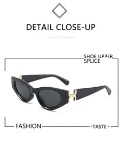 Gafas de sol de ojo de gato negras con detalle de bisagra dorada, estilo retro elegante.