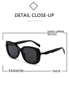 Close-up detail of trendy black square sunglasses, highlighting thick frames and dark lenses.