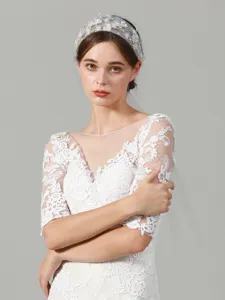 Detailed view of the exquisite lace bridal veil and floral headband, showcasing fine craftsmanship.