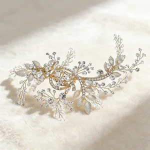 Gold rhinestone hair vine detail, elegant bridal leaf headpiece close up shot for wedding.